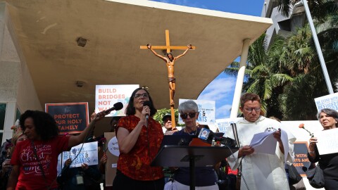 Religious leaders and Catholic church-goers attend a prayer vigil in honor of 25 detainees who died in ICE custody Nov. 13, 2025.