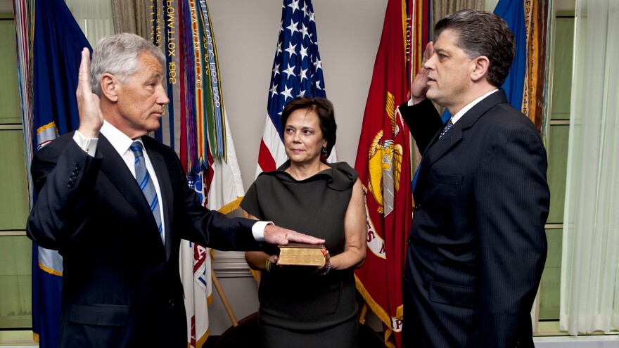 New Defense Secretary Chuck Hagel, left, as he was sworn in Wednesday morning at the Pentagon. His wife, Lilibet, held the Bible. Michael L. Rhodes, the Pentagon's director of administration and management, administered the oath.