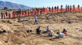 Pima County Historic Preservation Officer Ian Milliken speaks to a crowd at the Sunset Road archaeological site during a public viewing event in 2016.