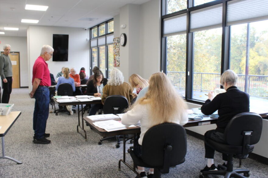 Staff at the Linn County Clerk’s Office count ballots and blue envelopes separately.