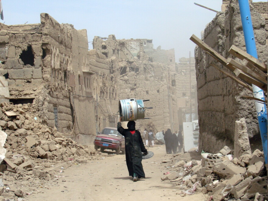 A Yemeni woman walks through a heavily damaged neighbourhood in the war-battered city of Saada, 240 kms (150 miles) north of the Yemeni capital Sanaa, on March 8, 2010, one month after a truce was declared between the Shiite rebels and government forces. Dammaj, in Saada province, is currently outside of effective Yemeni government control.