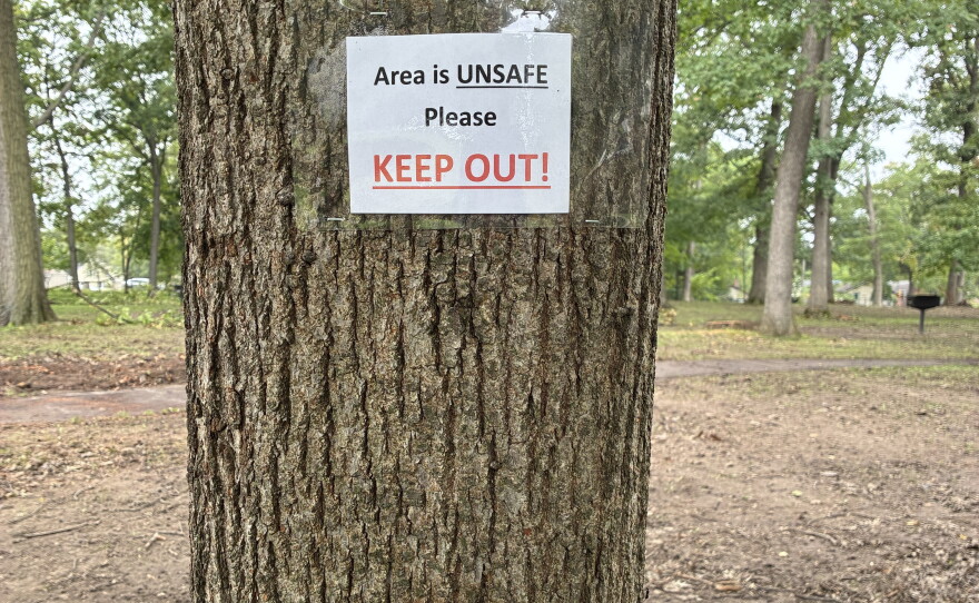 Area is unsafe, please keep out sign on a tree