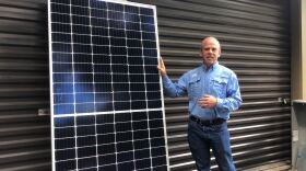 Solar Impact President Barry Jacobson shows a typical home solar installation, which is 400 watts of energy. (Jessica James/WUFT News)