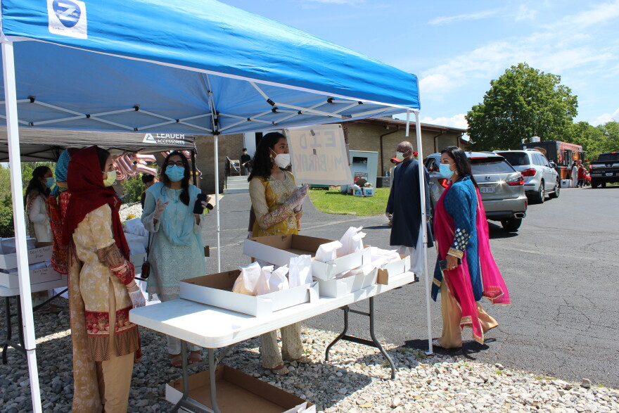 Volunteers handed out prepackaged doughnuts and tea to cars as they drove through the parking lot.