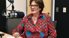 Molly Melching sitting in front of microphone