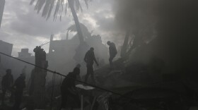 Palestinians look for the survivors of an Israeli strike in Rafah, Gaza Strip, Thursday, Nov. 14, 2023.
