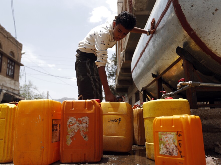 A Yemeni boy fills jerrycans with safe drinking water from a donated water tank in Sanaa earlier this month. The collapse of Yemen's infrastructure after more than two years of war between the Saudi-backed government and Shiite rebels who control the capital has made for a "perfect storm for cholera," according to a World Health Organization official.