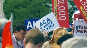 Demonstrators gather outside the Supreme Court on Thursday after the ruling that Affordable Care Act subsidies are constitutional.