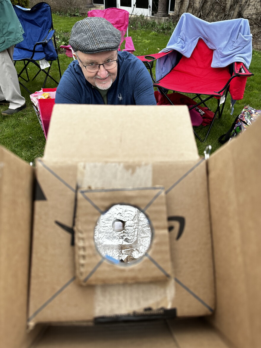 Henry Sowizral with his homemade pinhole telescope at the George Eastman Museum. He and his wife traveled from the West Coast to witness their second totality.