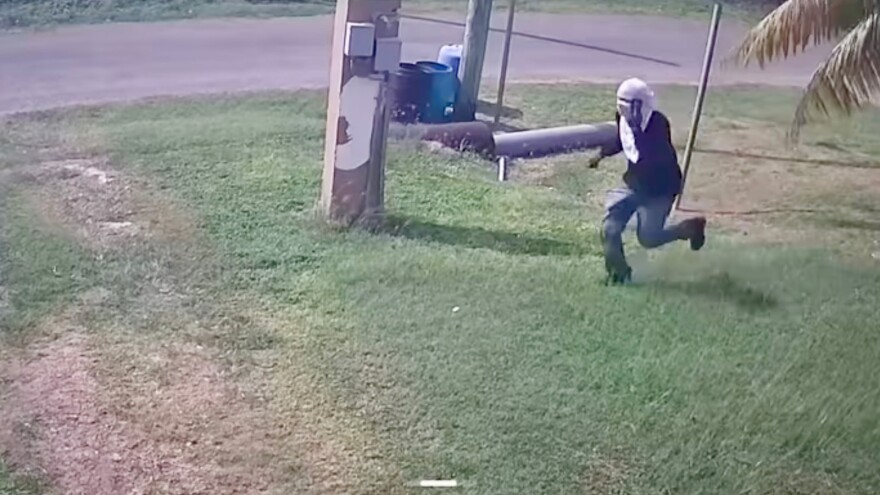 Pictured: Surveillance showing the suspect running through private yards.