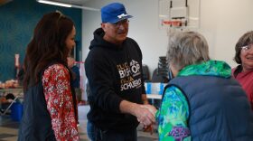 Click Bishop (center) shakes hands with Kotzebue residents at a meet-and-greet event on July 14.