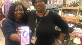 Michelle Williams, left, holding a picture of her sister Tracy, standing with Monica McInnis.