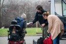 A staff member for Project.ME hands a man a new pair of socks, along with his lunch and other needs, outside of a hotel in northwest Fort Wayne on Tuesday, March 10. The organization hands out free lunches every Tuesday at noon and drives around the area hotels, offering supplies and food to anyone staying inside.