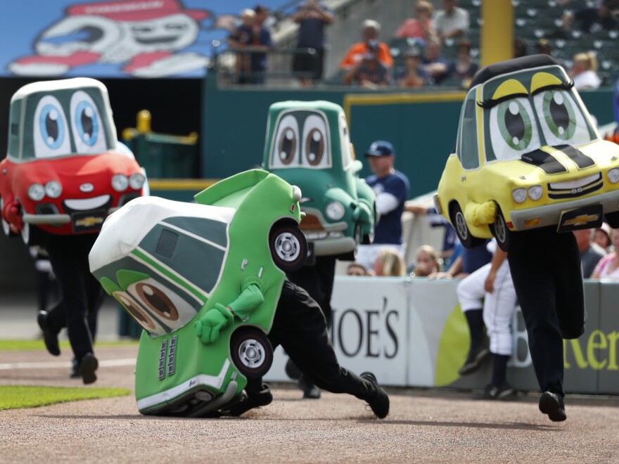 A Motor City Wheels mascot race participant crashes in the fourth inning of a baseball game between the Detroit Tigers and Minnesota Twins in Detroit in 2018.