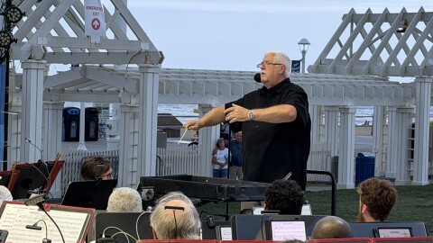 John Brewington conducting the Tidewater Winds Concert Band last month during a free concert at the Oceanfront. Brewington is the inaugural Champion for the Arts Educator for the city