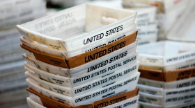 In this 2017 file photo, boxes for sorted mail are stacked at the main post office in Omaha, Neb.