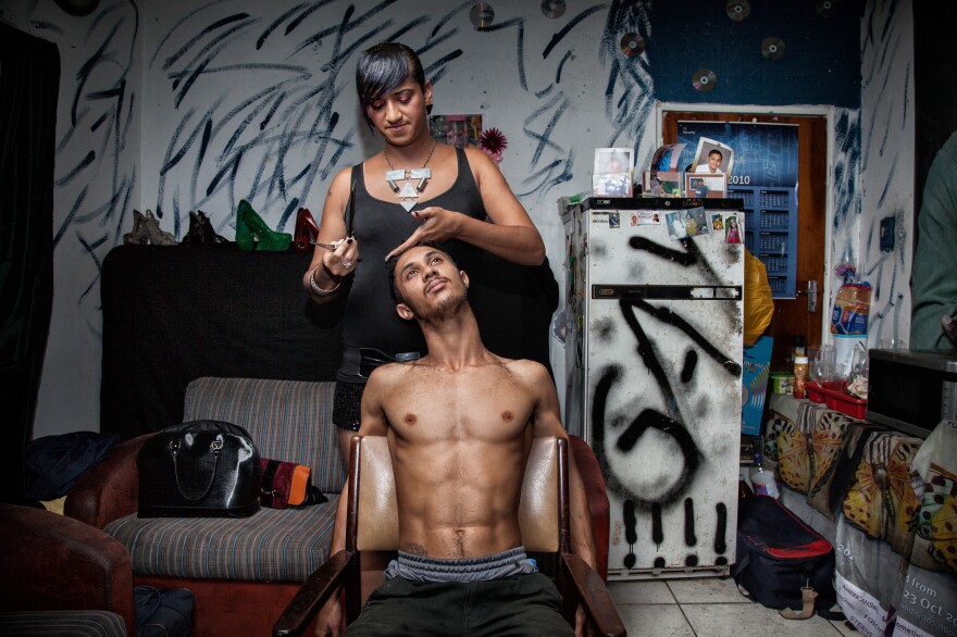 Chedino cuts the hair of a friend at Miss Whall's house in Ravensmead, Cape Town, South Africa, in 2014. Aside from her job in a call center, Chedino worked as a hairdresser to earn some extra money. As a teenager, Chedino was often employed as her family's hairstylist and make-up artist. "Whenever anyone had any fashion questions or needed styling, they would ask me."