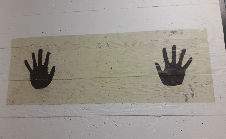 Two hands are painted on the wall mark the area where detainees are supposed put their own before they were processed at the former INS building.