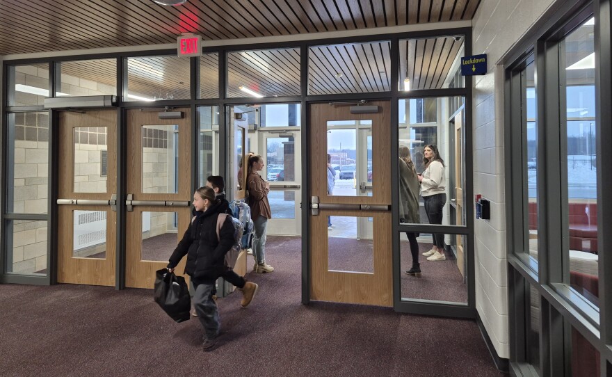 Two students walk into their new school early Tuesday morning.
