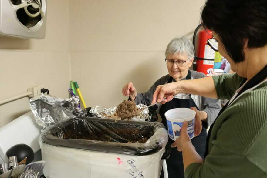 A team of women work together to cook all of the homemade food for the Rock-A-Thon. Connie Schou, in green, and Naomi Adams load up the leftover jaternice.