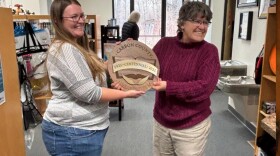 Jenita Carlson, the interim library director for the Carbon County Library System, awarded Elk Mountain Branch Manager Jessica Mustard an award during a week of celebrations in December 2025.