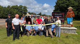 Ribbon cutting for the new electronic Smokey fire danger sign in Minocqua