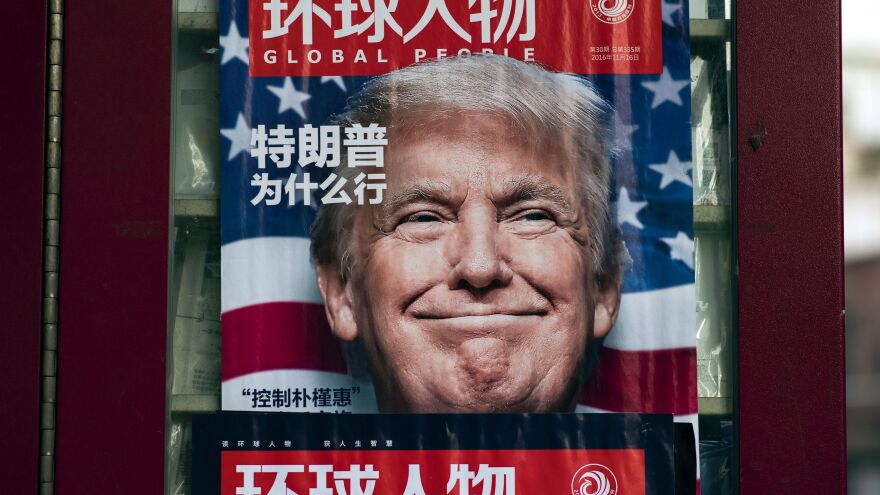 This picture taken on Dec. 14, 2016, at a news stand in Shanghai shows an advertisement for a magazine featuring Donald Trump, who would soon take office as president, on the cover.
