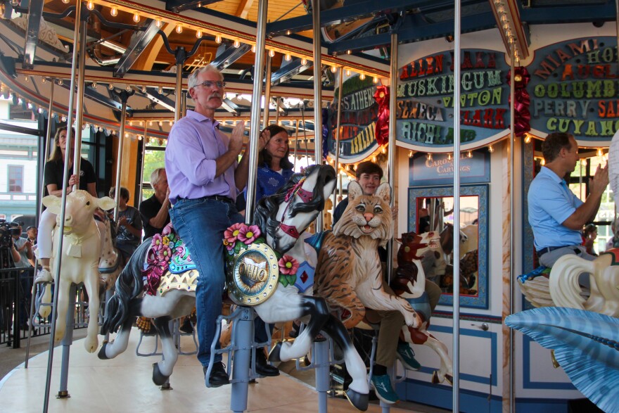 Todd Goings, president of Carousels and Carvings in Marion, sits on a horse during the inaugural ride of the new carousel at the Ohio State Fairgrounds.