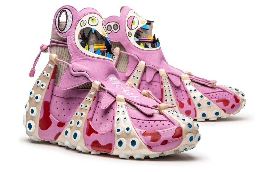 A pair of elaborate pink high-top sneakers