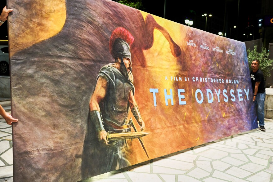 Workers install a hand-painted billboard, painted by artist Virginia Axioti, for Christopher Nolan's upcoming film "The Odyssey," starring Matt Damon as Odysseus, outside Athens' Athinaion cinema, Saturday, July 11, 2026.