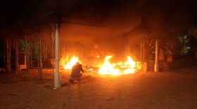 A vehicle and the surrounding area are engulfed in flames after it was set on fire inside the U.S. consulate compound in Benghazi late on September 11, 2012. An armed mob protesting over a film they said offended Islam, attacked the U.S. consulate in Benghazi and set fire to the building.