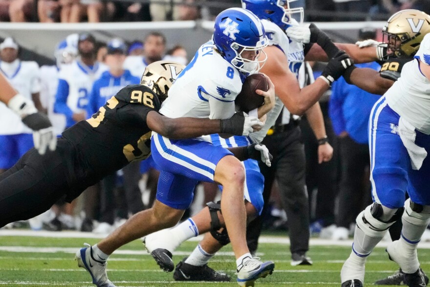Vanderbilt defensive lineman Khordae Sydnor (96) tackles Kentucky quarterback Cutter Boley (8) during the first half of an NCAA college football game Saturday, Nov. 22, 2025, in Nashville, Tenn. (AP Photo/George Walker IV)