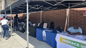 Nonprofits and city services set up in the Penn North neighborhood for a resource fair on Monday, July 28, 2025. Photo by Scott Maucione/WYPR.