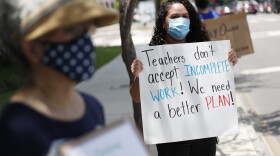 First grade teacher Yolanda Vasquez stands in protest along with other teachers and counselors in front of the Hillsborough County Schools District Office on July 16, 2020 in Tampa, Florida.  (Octavio Jones/Getty Images)
