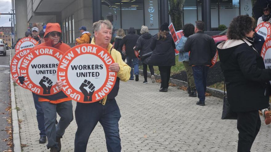 Union supporters march outside the Hyatt Regency hotel, calling for hotel owner Douglas Jemal to join labor discussions.