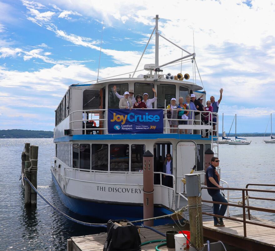 Passengers on the Joy Cruise held by Comfort Keepers wave from the upper deck of The Discovery Cruise ship before heading onto the waters of West Grand Traverse Bay. They were out on Wednesday, June 26, the National Day of Joy.