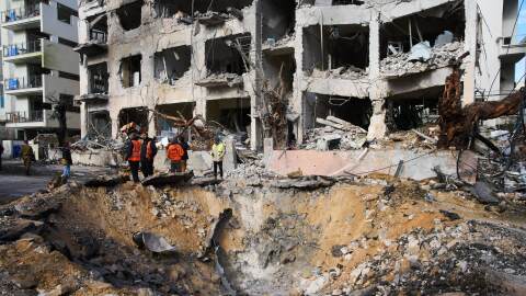 Rescue workers and military personnel survey the scene of a direct hit a day after an Iranian missile struck in Tel Aviv, Israel, Sunday, March 1, 2026. (AP Photo/Oded Balilty)