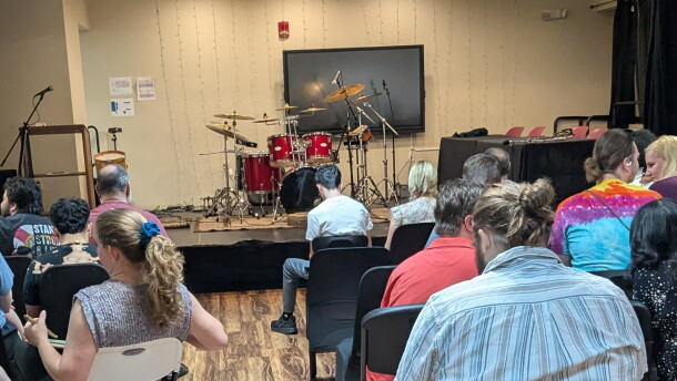 The expectant crowd waits as the competitors get ready to demonstrate their skills behind a massive drum set