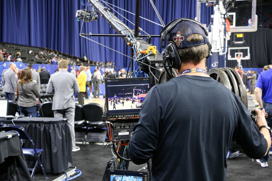 A camerman captures a Louisiana high school basketball tournament (New Orleans girls beat Baton Rouge!). His is one of many thousands of jobs created by the NBA All-Star Game.