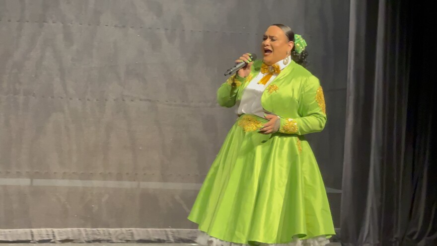 Hazel Rose Suarez Performing at Voz de la Paloma in a bright green charro suit with yellow embroidery 