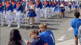 Gainesville residents take in the University of Florida Gator Marching Band at UF's Homecoming Parade on Friday, Oct. 17, 2025. (Sara-James Ranta/WUFT News)