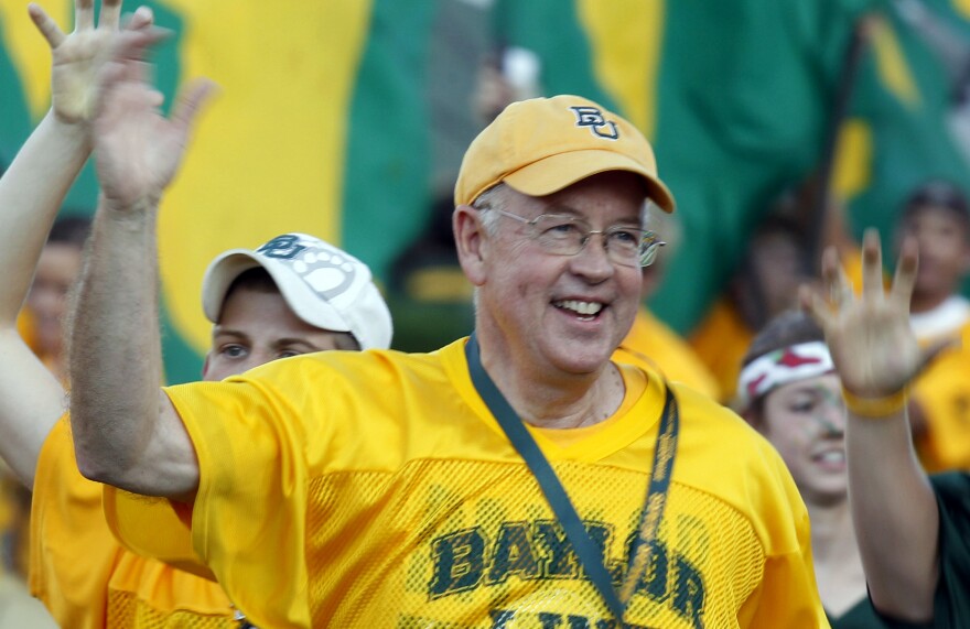 Baylor University President Kenneth Starr runs onto the football field before a 2011 game against Texas Christian University in Waco, Texas. Starr became president of Baylor in 2010.