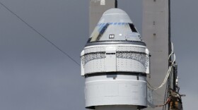 Boeing's Starliner capsule atop an Atlas V rocket is rolled out to the launch pad