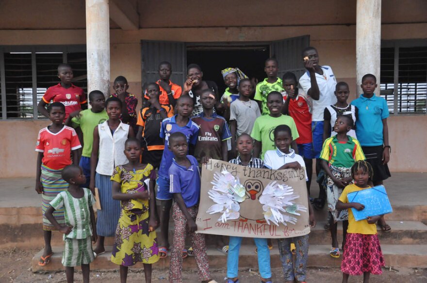 Students in the English club in the village of Gouandé, Benin, learned about the holiday of Thanksgiving from Peace Corps volunteer Abby Reilly, then wrote what they were thankful for on feathers and pasted them on a poster of a turkey that she'd made.