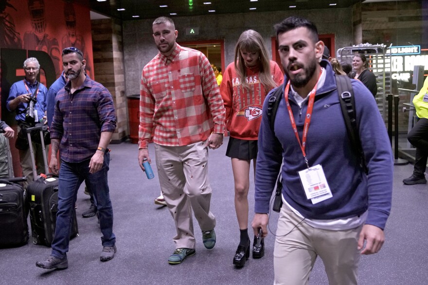 Kansas City Chiefs tight end Travis Kelce, center left, and singer Taylor Swift leave Arrowhead stadium after an NFL football game between the Chiefs and the Los Angeles Chargers, Sunday, Oct. 22, 2023, in Kansas City, Missouri.