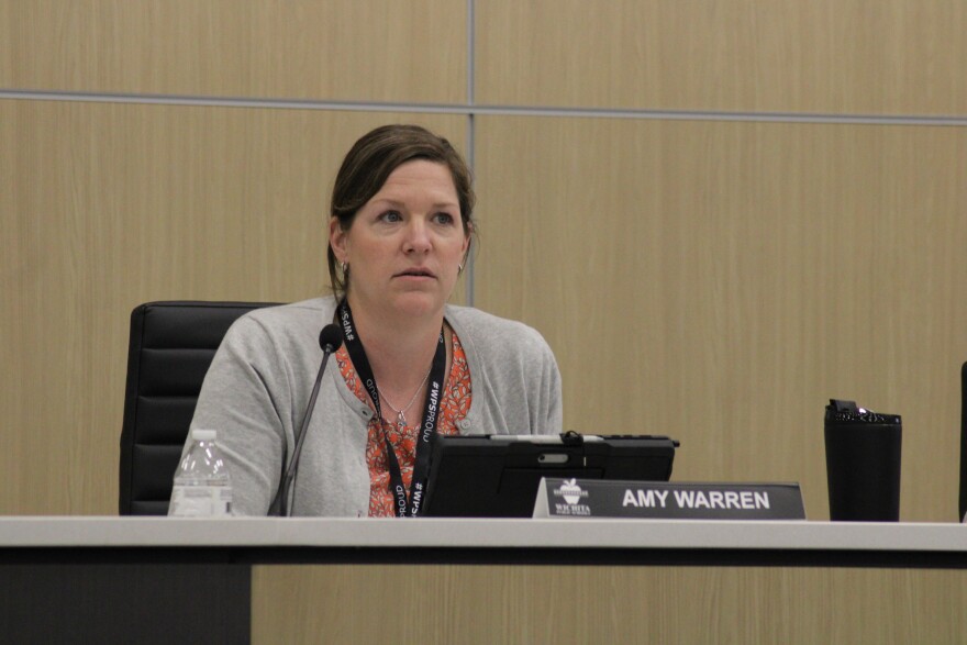 Wichita school board member Amy Warren speaks during the meeting on Monday. She tried to persuade her colleagues to reconsider closing the schools.