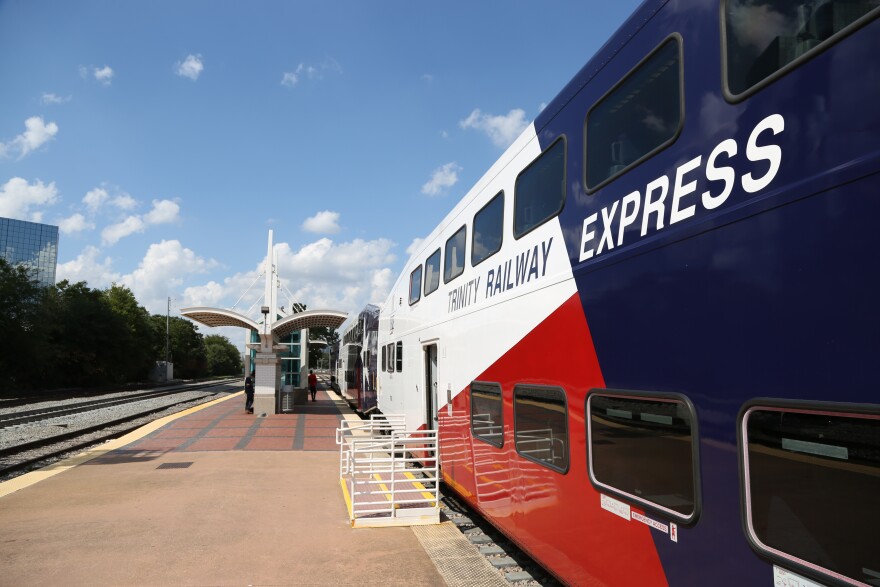 Trinity River Express train picks up passengers and a stop.