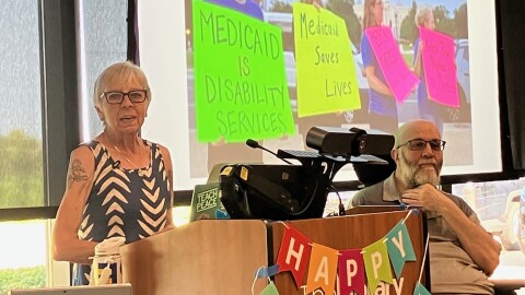 Sue Dinsdale, director of the Iowa Citizen Action Network, speaks Wednesday, July 29 at the Davenport Public Library Eastern Avenue branch, while Doug Sample of Davenport listens.