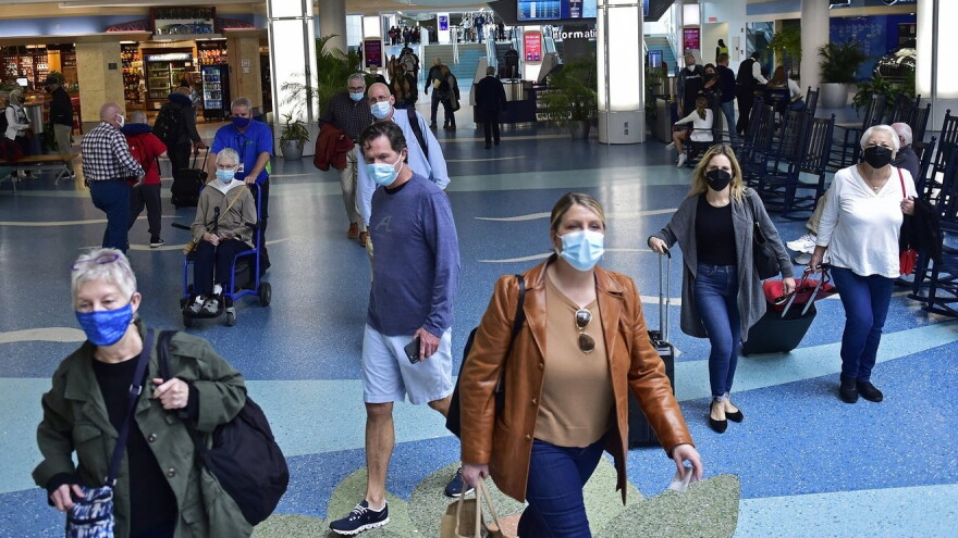 Travelers make their way to security before checking in at their gates on Monday as the Thanksgiving travel period begins at Jacksonville International Airport.