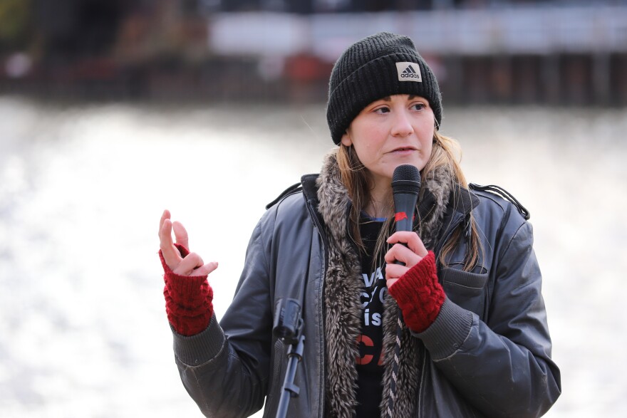 Beth Vild speaking at a microphone.